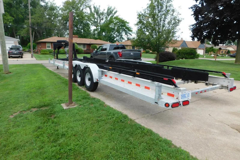 Slide: The Image of Trailer parked on driveway, suitable for 2006 Fountain 38 LX boat transport. - 83