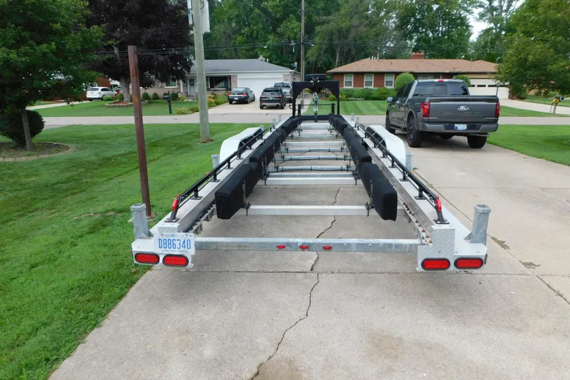 Slide: The Image of Trailer for 2006 Fountain 38 LX boat parked in residential driveway. - 82