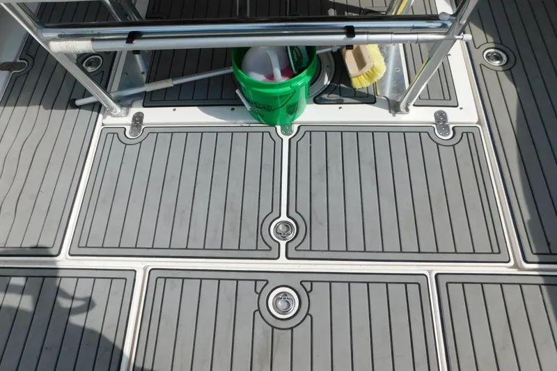 Slide: The Image of Deck of 2006 Fountain 38 LX boat with cleaning supplies and textured flooring. - 67