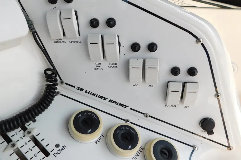 Slide: The Image of Control panel of a 2006 Fountain 38 LX boat with various switches and dials. - 26