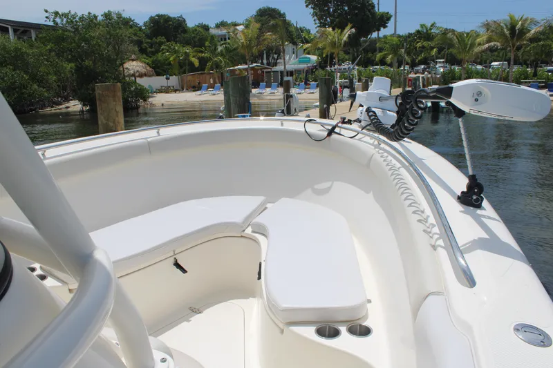 Slide: The Image of 2009 Pursuit C 310 Center Console boat docked near tropical shoreline. - 12