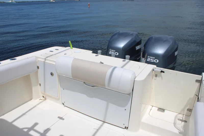 Slide: The Image of 2009 Pursuit C 310 Center Console boat with twin Yamaha 250 engines on calm water. - 6