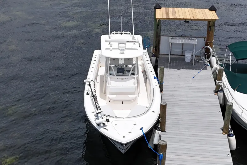 Slide: The Image of 2009 Pursuit C 310 Center Console boat docked at a marina. - 3