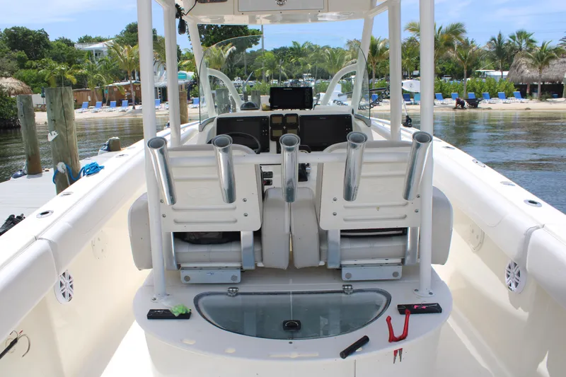 Slide: The Image of 2009 Pursuit C 310 Center Console boat interior with fishing rod holders and control panel. - 7