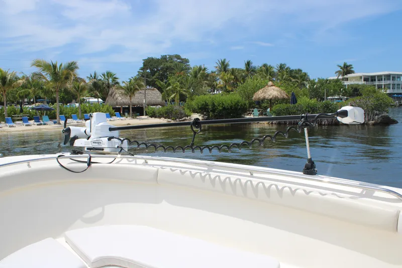 Slide: The Image of 2009 Pursuit C 310 Center Console boat near tropical beach with palm trees. - 13