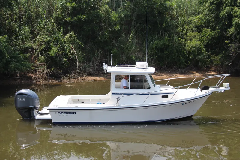 The Image of 2022 Steiger Craft 21 Miami boat on calm water, surrounded by lush greenery. - 0