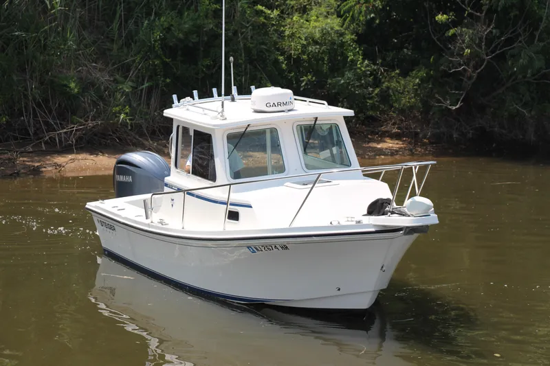 Slide: The Image of 2022 Steiger Craft 21 Miami boat on calm water, featuring Yamaha engine and Garmin equipment. - 16