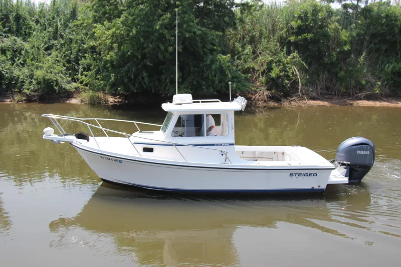 Slide: The Image of 2022 Steiger Craft 21 Miami boat cruising on a calm river with lush greenery. - 3