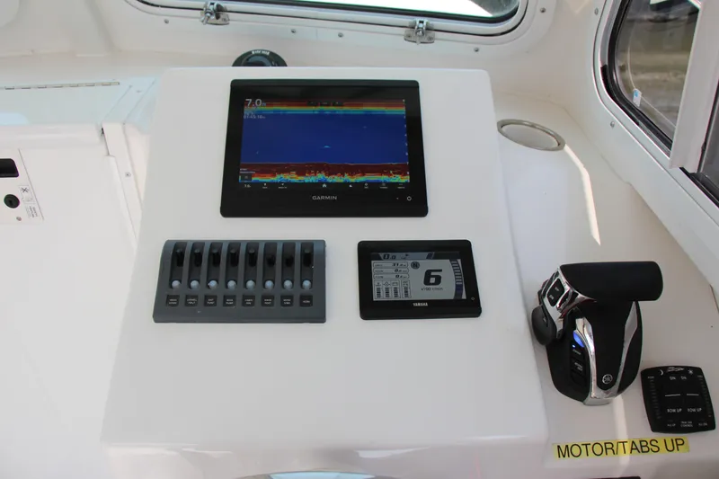 Slide: The Image of Steiger Craft 21 Miami 2022 boat dashboard with Garmin display and controls. - 33