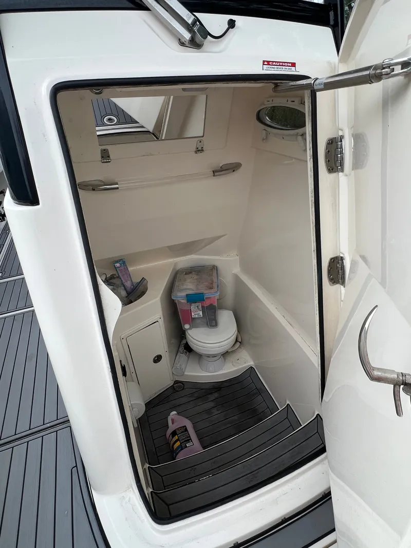 Slide: The Image of Interior view of a boat cabin with a toilet and storage space. - 18