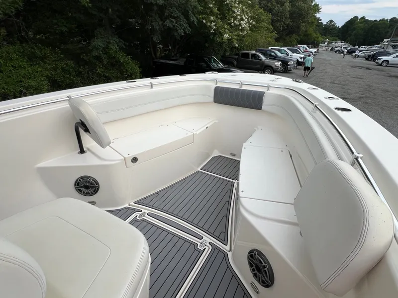 Slide: The Image of The image shows the bow area of a 2020 Cobia 280 Center Console boat with white seating. - 15