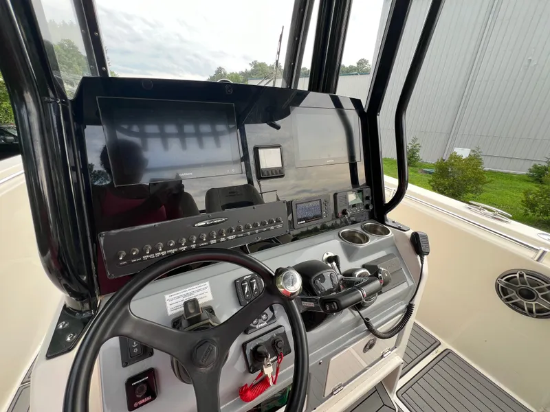 Slide: The Image of The image shows the cockpit of a 2020 Cobia 280 Center Console boat with modern electronics. - 9