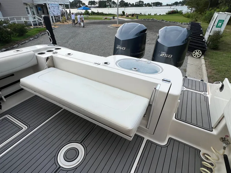 Slide: The Image of The image shows the stern of a Cobia 280 Center Console boat with two outboard engines. - 12