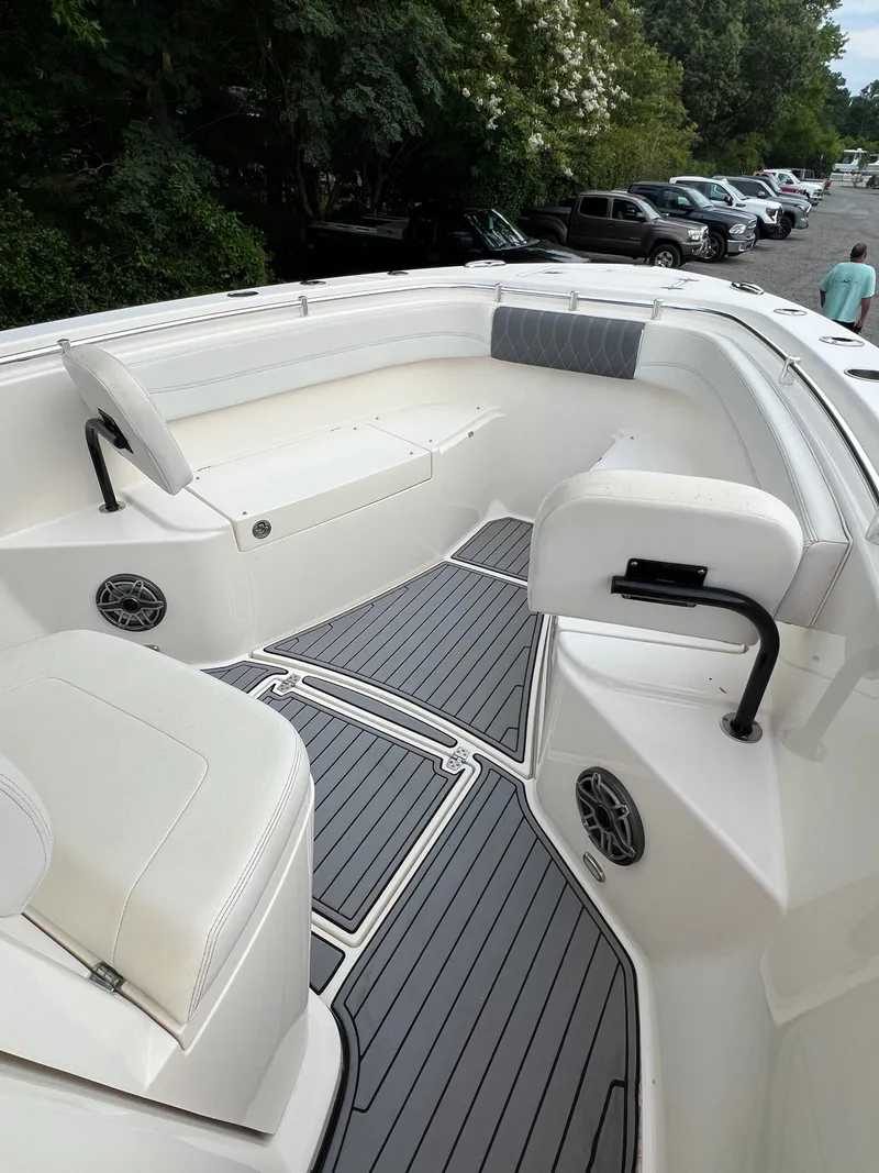 Slide: The Image of The image shows the bow area of a 2020 Cobia 280 Center Console boat with white seating and gray flooring. - 14