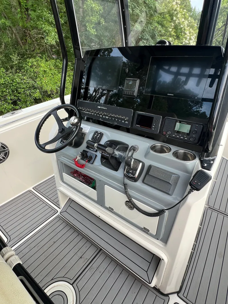 Slide: The Image of The image shows the cockpit of a 2020 Cobia 280 Center Console with modern electronics. - 8