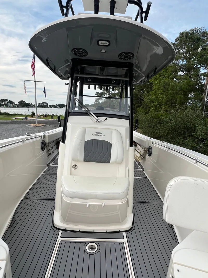 Slide: The Image of The image shows a 2020 Cobia 280 Center Console boat with a gray deck and white seating. - 17