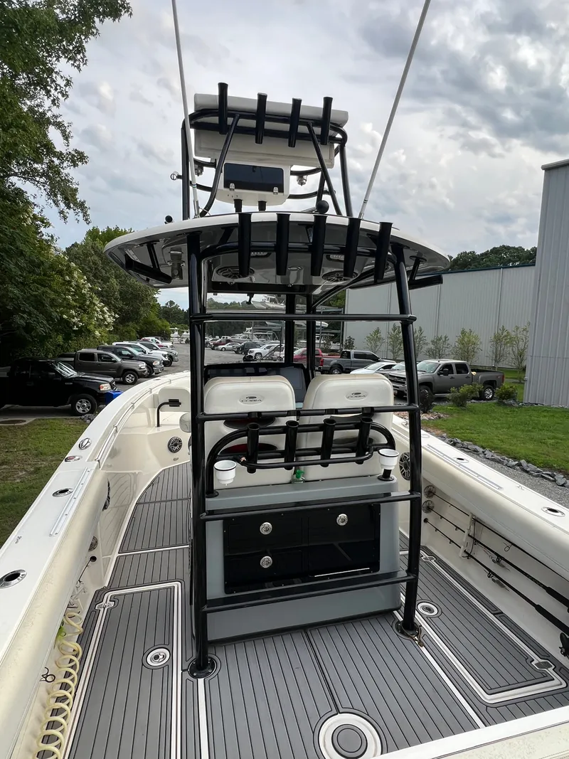Slide: The Image of The image shows the cockpit of a 2020 Cobia 280 Center Console boat with T-top and seating. - 5