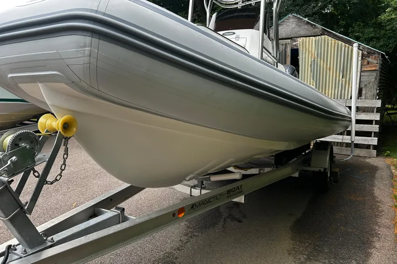 Slide: The Image of 2022 AB Inflatables Nautilus 19 DLX boat on trailer, parked outdoors. - 2