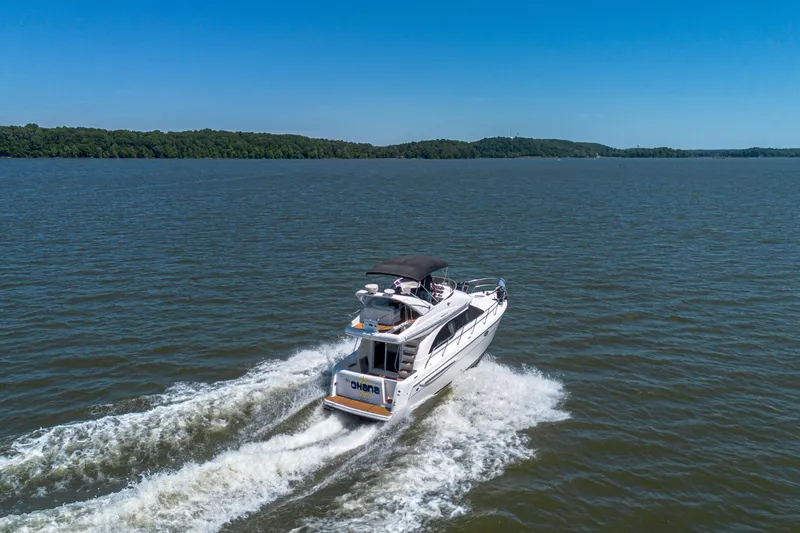 Slide: The Image of 2005 Meridian 341 Sedan cruising on a serene lake under a clear blue sky. - 15