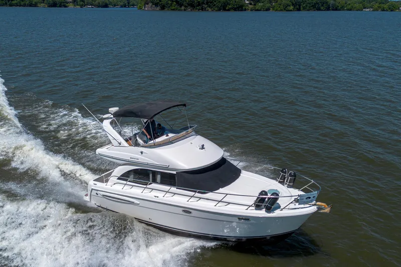 Slide: The Image of 2005 Meridian 341 Sedan cruising on a lake under clear skies. - 17