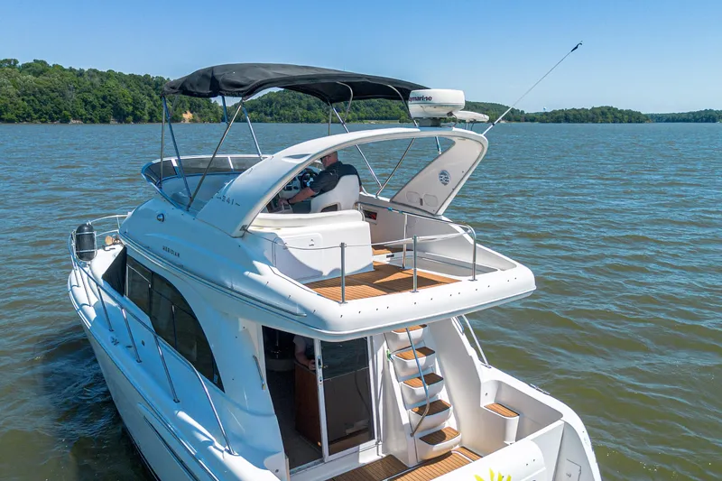 Slide: The Image of 2005 Meridian 341 Sedan cruising on a serene lake under clear blue skies. - 25