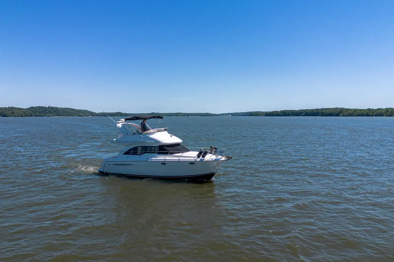 Slide: The Image of 2005 Meridian 341 Sedan cruising on a serene lake under a clear blue sky. - 10
