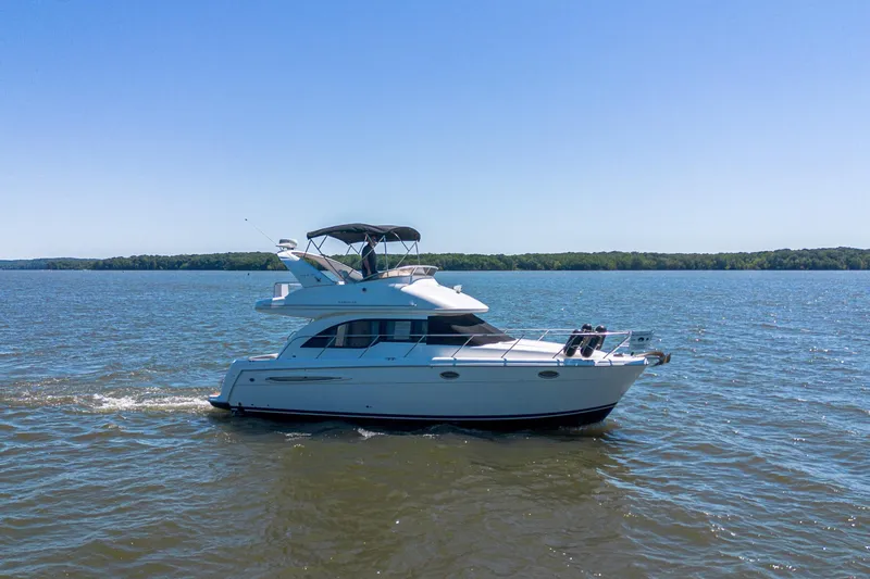 Slide: The Image of 2005 Meridian 341 Sedan cruising on a serene lake under a clear blue sky. - 7