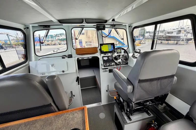 Slide: The Image of Interior of 2018 Hewescraft 260 Pacific Explorer boat, featuring helm and navigation equipment. - 3
