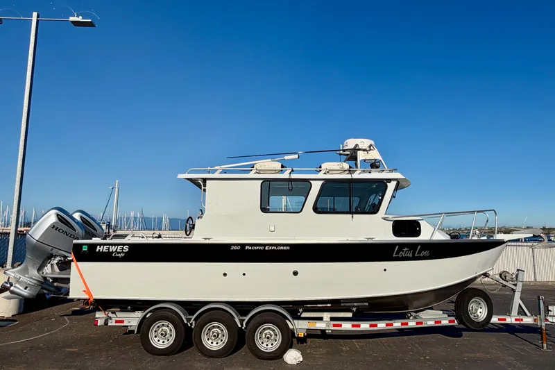 Slide: The Image of 2018 Hewescraft 250 Pacific Explorer boat on trailer, dockside view. - 0