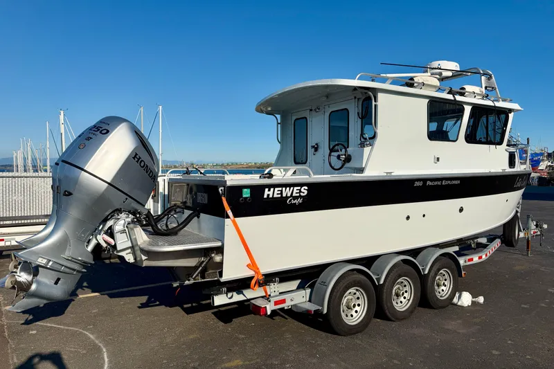 Slide: The Image of 2018 Hewescraft 250 Pacific Explorer boat on trailer with Honda outboard motor. - 2