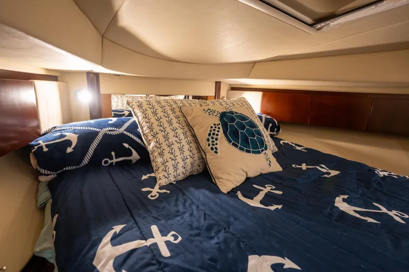 Slide: The Image of Luxurious 2006 Sea Ray 455 Sedan Bridge cabin with nautical-themed bedding and turtle pillow. - 39