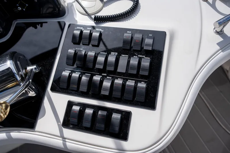 Slide: The Image of Control panel of a 2006 Sea Ray 455 Sedan Bridge yacht with various switches. - 28