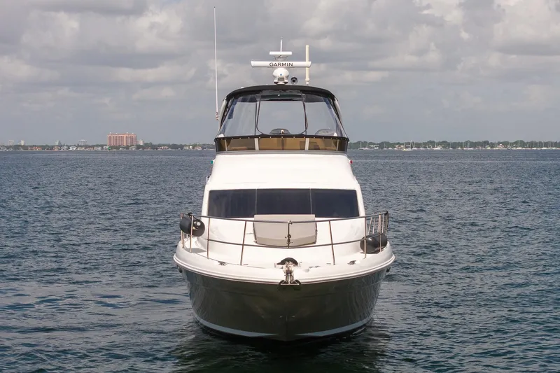 Slide: The Image of 2006 Sea Ray 455 Sedan Bridge yacht on open water, front view. - 9