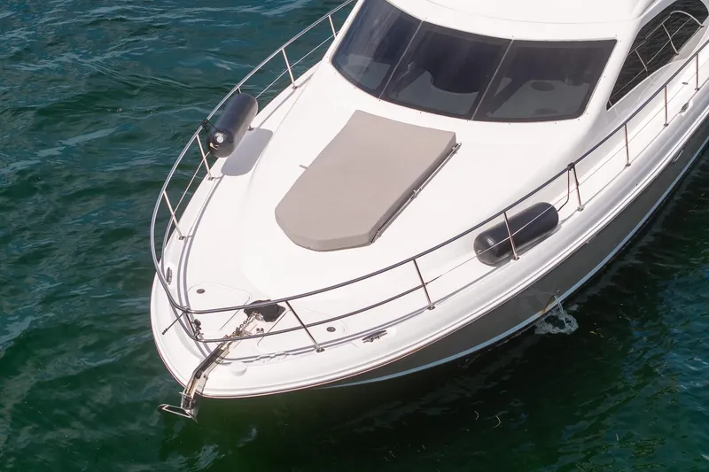 Slide: The Image of 2006 Sea Ray 455 Sedan Bridge yacht on water, top view of bow and deck. - 32