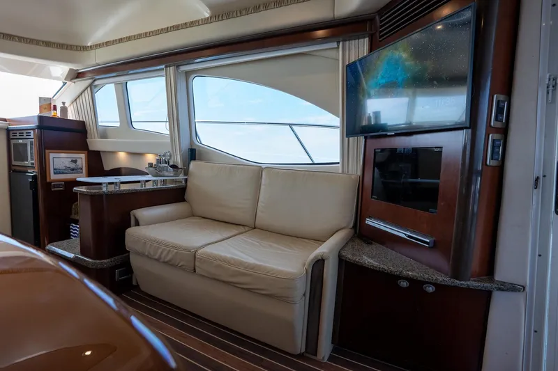 Slide: The Image of Luxurious interior of 2006 Sea Ray 455 Sedan Bridge yacht with sofa and TV. - 21