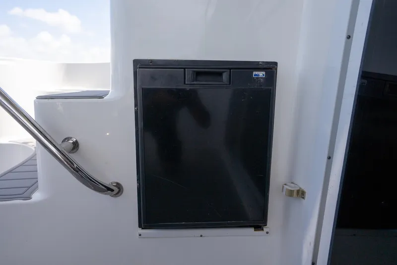 Slide: The Image of Compact black refrigerator on 2006 Sea Ray 455 Sedan Bridge yacht deck. - 26