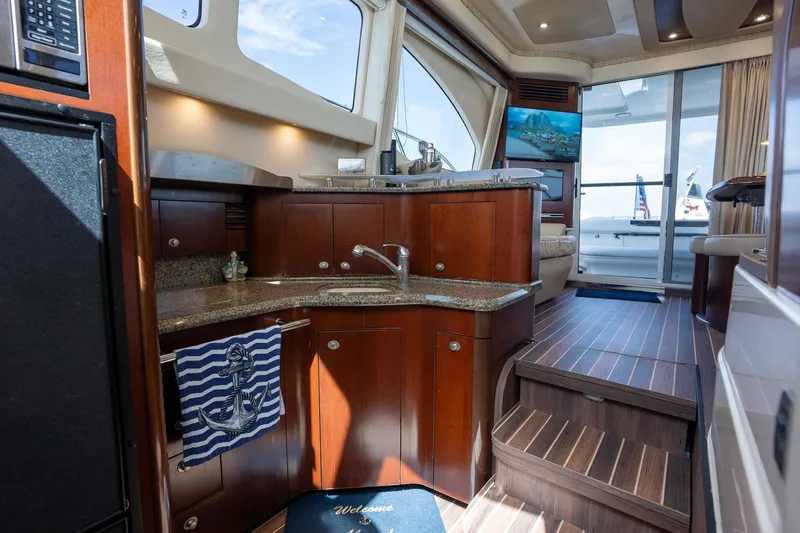 Slide: The Image of Luxurious interior of 2006 Sea Ray 455 Sedan Bridge yacht with elegant wood finishes. - 23