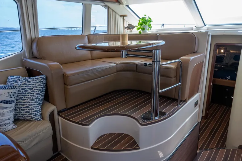 Slide: The Image of Luxurious interior of 2006 Sea Ray 455 Sedan Bridge with leather seating and elegant wood flooring. - 18