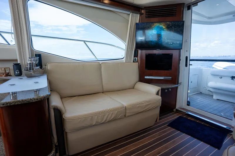 Slide: The Image of Luxurious interior of 2006 Sea Ray 455 Sedan Bridge yacht with sofa and TV. - 34