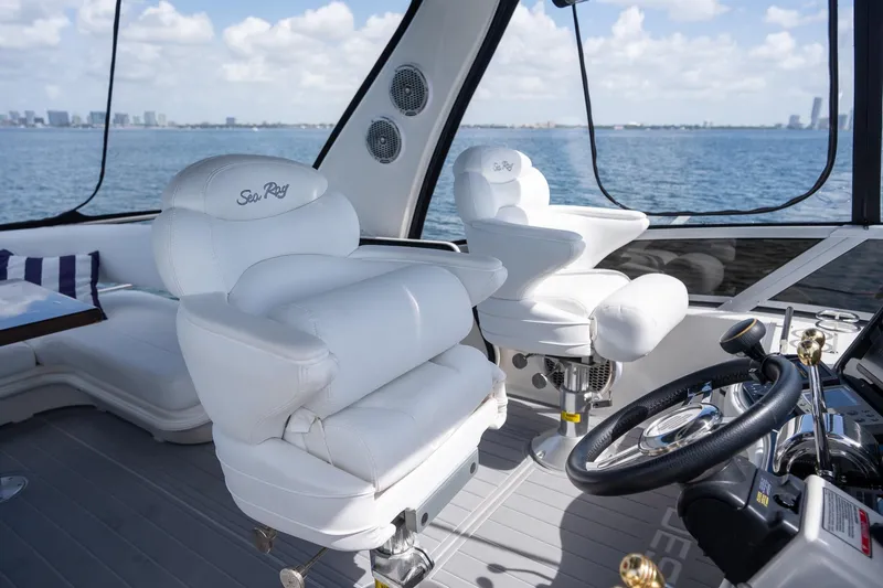 Slide: The Image of Luxurious interior of 2006 Sea Ray 455 Sedan Bridge yacht with white seating and ocean view. - 29