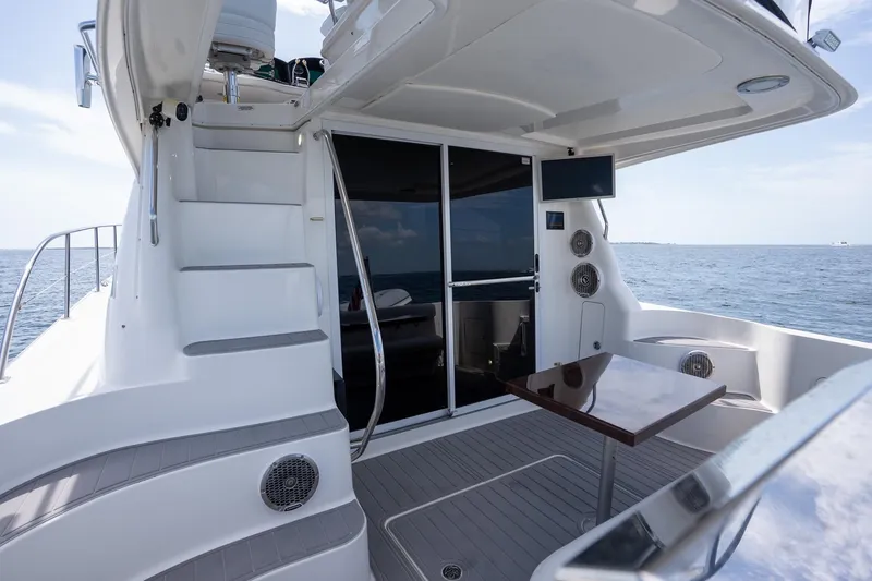 Slide: The Image of 2006 Sea Ray 455 Sedan Bridge yacht interior with stairs, table, and ocean view. - 35