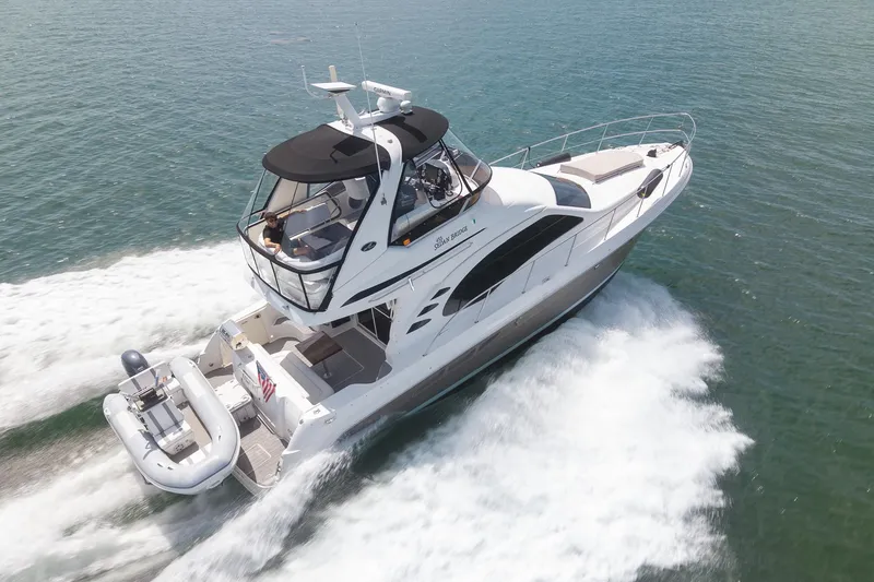 Slide: The Image of 2006 Sea Ray 455 Sedan Bridge yacht cruising on open water. - 1