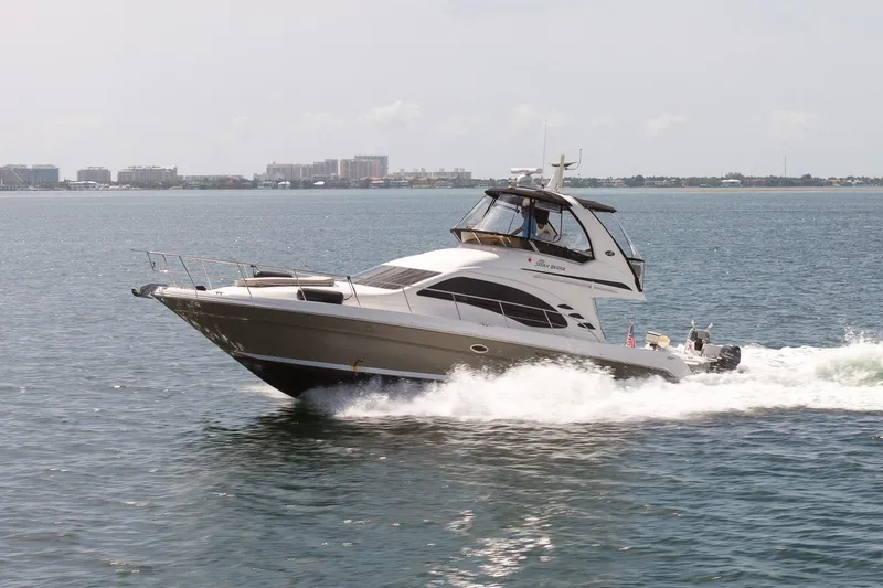 Slide: The Image of 2006 Sea Ray 455 Sedan Bridge yacht cruising on open water. - 8