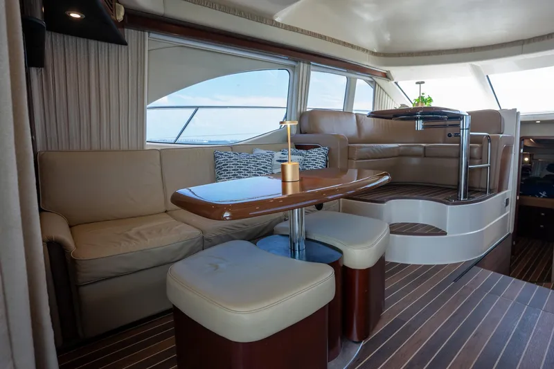 Slide: The Image of Luxurious interior of 2006 Sea Ray 455 Sedan Bridge yacht with elegant seating and table. - 17