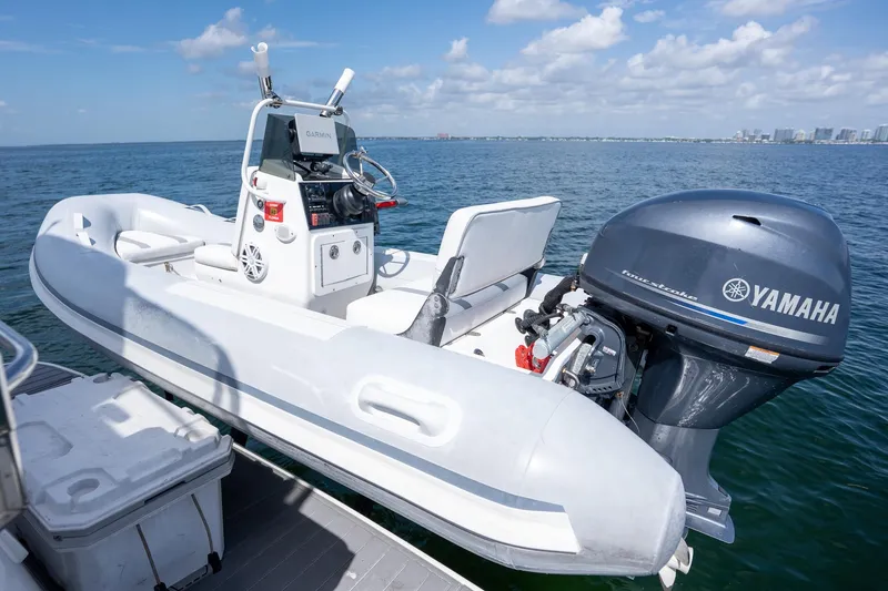 Slide: The Image of A Yamaha-powered inflatable boat on water, viewed from a Sea Ray 455 Sedan Bridge. - 33