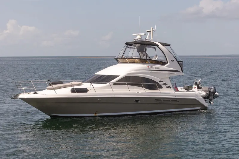 Slide: The Image of 2006 Sea Ray 455 Sedan Bridge yacht on calm ocean waters. - 2