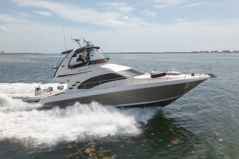 Slide: The Image of 2006 Sea Ray 455 Sedan Bridge cruising on open water, under clear skies. - 36