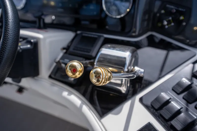Slide: The Image of Close-up of 2006 Sea Ray 455 Sedan Bridge helm controls with gold accents. - 31