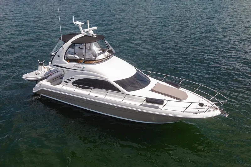Slide: The Image of 2006 Sea Ray 455 Sedan Bridge yacht cruising on open water. - 14