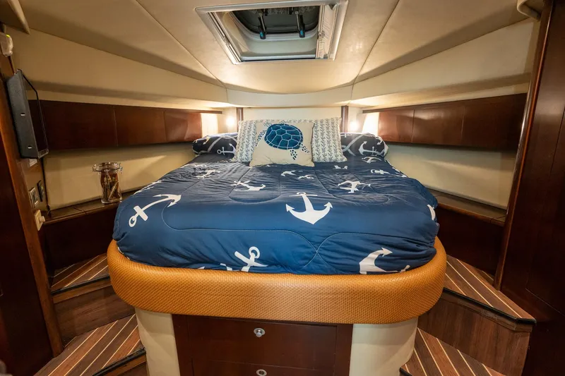 Slide: The Image of Luxurious 2006 Sea Ray 455 Sedan Bridge cabin with nautical-themed bedding. - 12